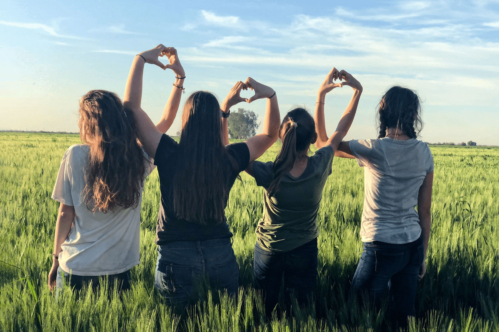 4 people making hearts by touching their hands together, support, community, support group, peer network, networking, chronic illness support, mental health support, mental health network